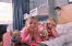 Familyroom with two happy girls in the bed